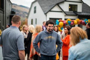 Man standing in a corwd wearing an Everton Ridge Homes Sweater