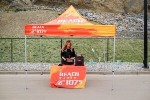 Woman in a radio announcing booth live on location for Morningview Grand Opening