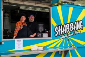 Two people standing inside Shabbang Food Truck at Morningview Grand Opening